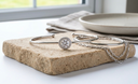 Silver moissanite halo Bangle,  on a cork board with a neutral background