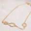 Gold bracelet with an infinity design on a light background