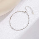 Layered Chain Bracelet – Silver option on a white fabric