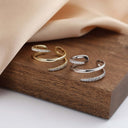 Sculpted Sparkle Adjustable Ring – 925 Silver, Hypoallergenic Fit. on a wooden board