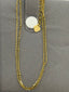 Beaded Gold chain anklet with a heart-shaped pendant on a grey background