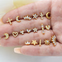 Gold 16g Cartilage Piercing Earrings featuring various designs including stars, moons, and hearts with sparkling crystals.