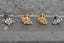 Close-up of push-fit titanium earrings in gold & silver, perfect for cartilage, tragus, and conch piercings. Hypoallergenic & waterproof for sensitive skin.