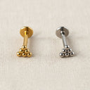 Gold and silver lip ring studs on a white background