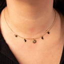Gold necklace with star, moon, and sun pendants on a textured beige background-Gold Celestial Gypsy Necklace – Station Necklace

18K Gold-Plated | Celestial | Hypoallergenic 