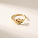 Leaf Open Band Ring – Sterling Silver. A gold open-bend ring featuring a detailed oak leaf design on the front, photographed on a clean, light beige background with soft shadows.