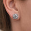 Close-up of a silver earring on an ear with a blurred background