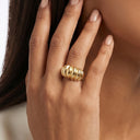 Sculpt Statement Ring -Gold ring on a hand with a blurred background