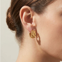Chunky Watch Link Huggie Hoop Earrings  worn by a person with a neutral background