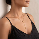 A close-up of a woman wearing Akuba Teardrop Necklace | Premium Stainless Steel paired with a black lace camisole top.