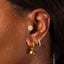 A model showing cuff earrings in a stacking style