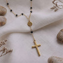 14K gold black beaded cross necklace flat lay