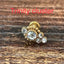 Close-up of push-fit titanium earrings in gold & silver, perfect for cartilage, tragus, and conch piercings. Hypoallergenic & waterproof for sensitive skin.