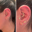 Close-up of push-fit titanium earrings in gold & silver, perfect for cartilage, tragus, and conch piercings. Hypoallergenic & waterproof for sensitive skin.
